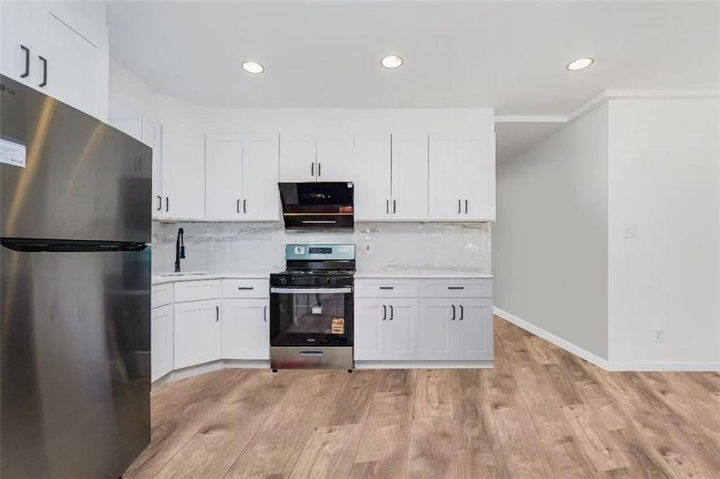 Interior, Kitchen, Marble Walls, Recessed Lighting, Stainless Steel Appliances, Wood Texture Flooring