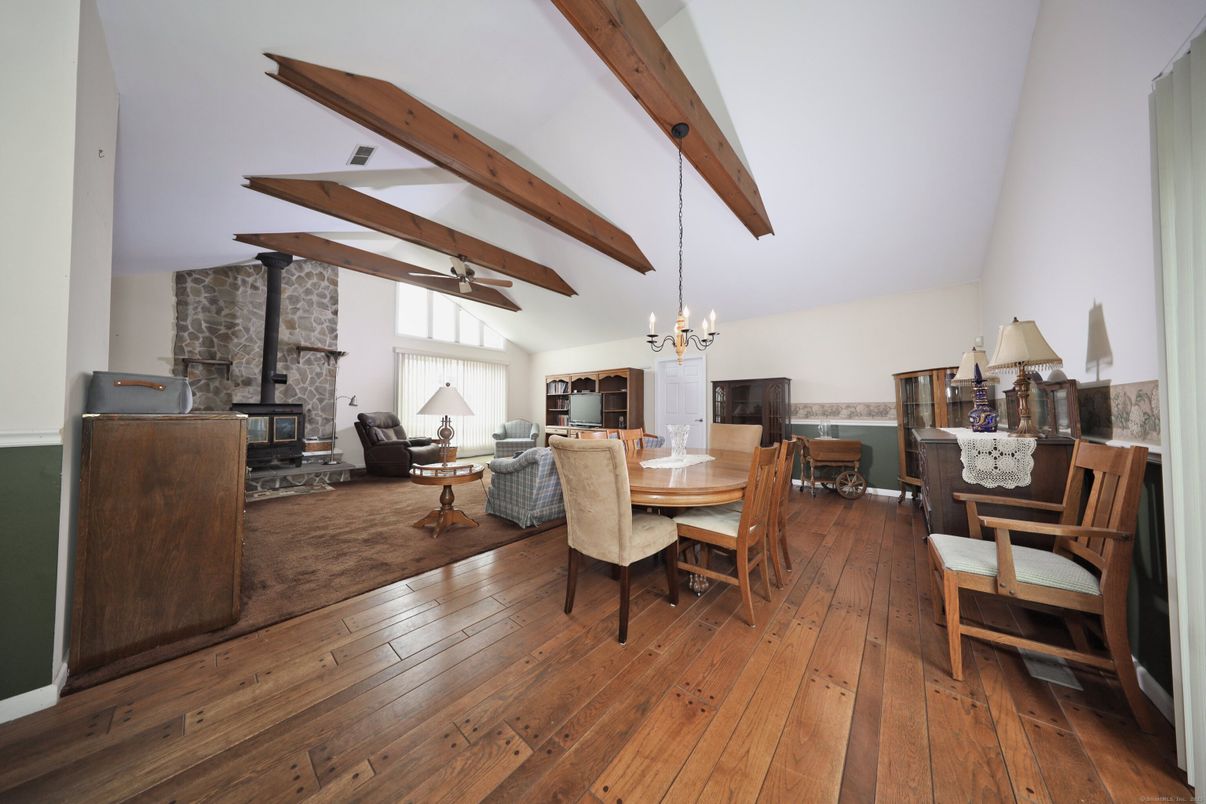 Chandelier, Dining room, Fireplace, Interior, Living room, Pendant Lights, Stone Walls, Wooden Beams, Wood Texture Flooring