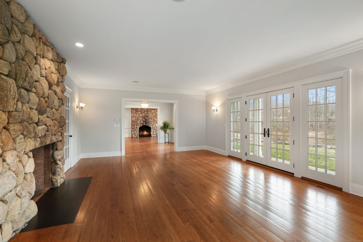 Empty room, Fireplace, Interior, Recessed Lighting, Stone Walls, Wood Texture Flooring