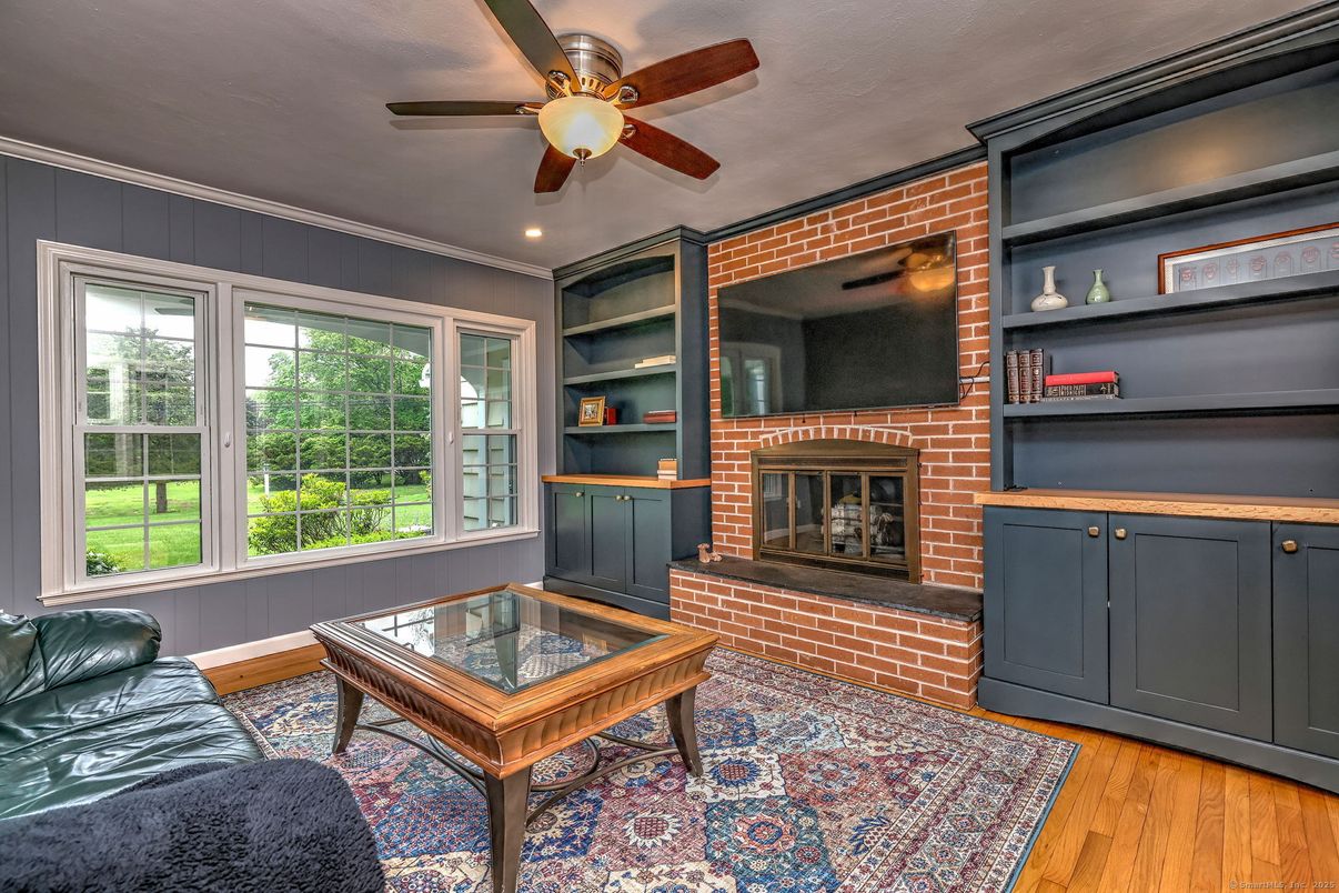 Fireplace, Interior, Living room, Recessed Lighting, Stone Walls, Wood Texture Flooring