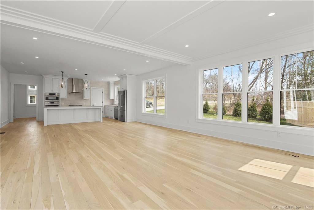 Empty room, Interior, Kitchen, Pendant Lights, Recessed Lighting, Stainless Steel Appliances, Wood Texture Flooring