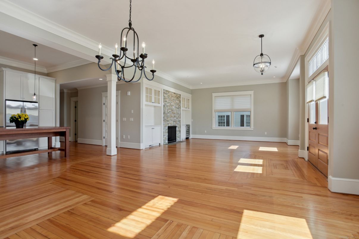 Chandelier, Empty room, Fireplace, Interior, Kitchen, Pendant Lights, Recessed Lighting, Wood Texture Flooring