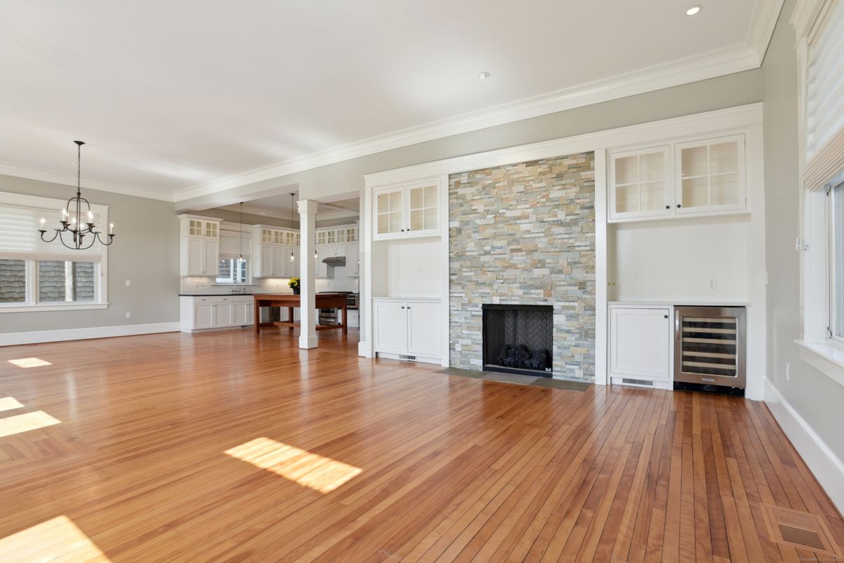 Chandelier, Empty room, Fireplace, Interior, Kitchen, Recessed Lighting, Stone Walls, Wood Texture Flooring
