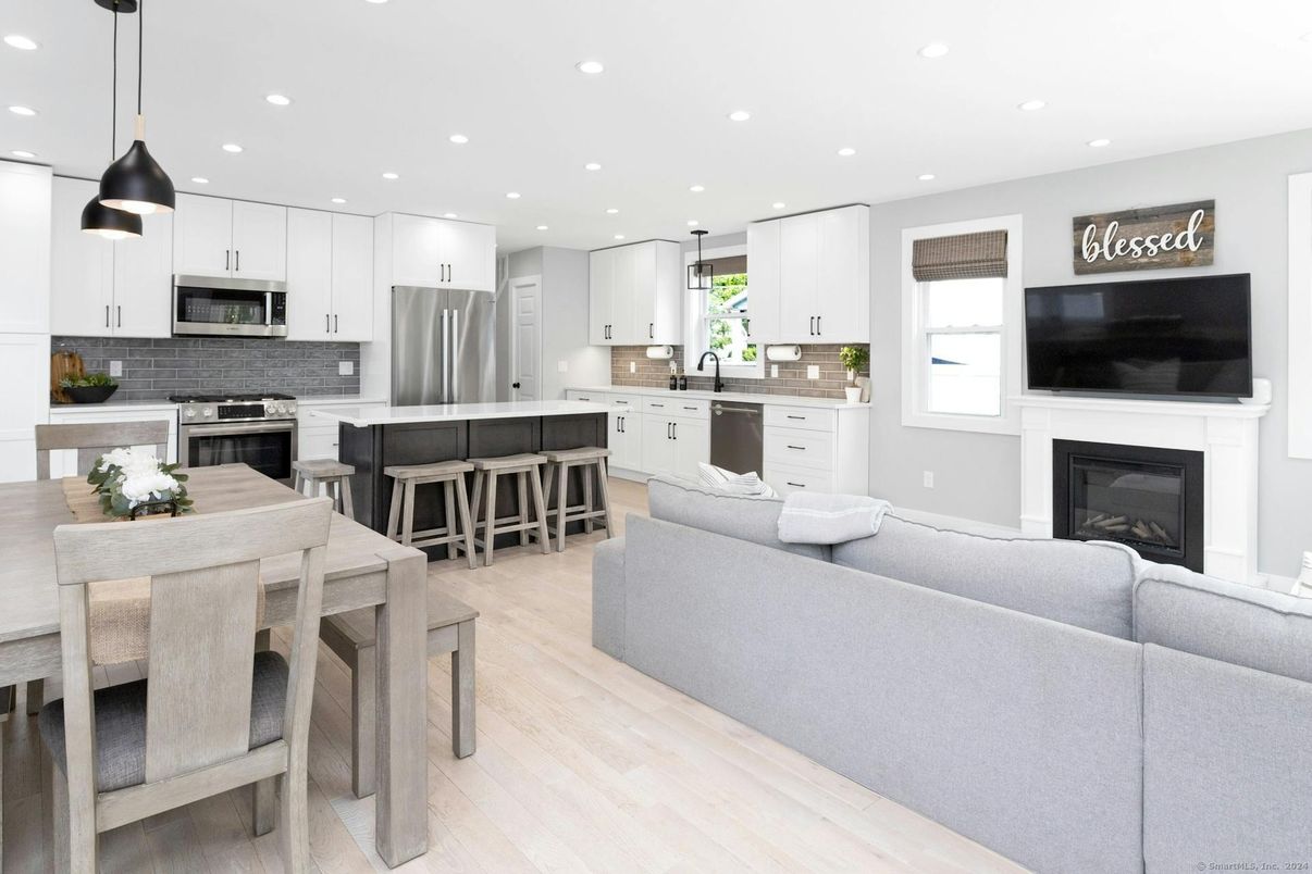 Dining room, Fireplace, Interior, Kitchen, Living room, Pendant Lights, Recessed Lighting, Stainless Steel Appliances, Wood Texture Flooring