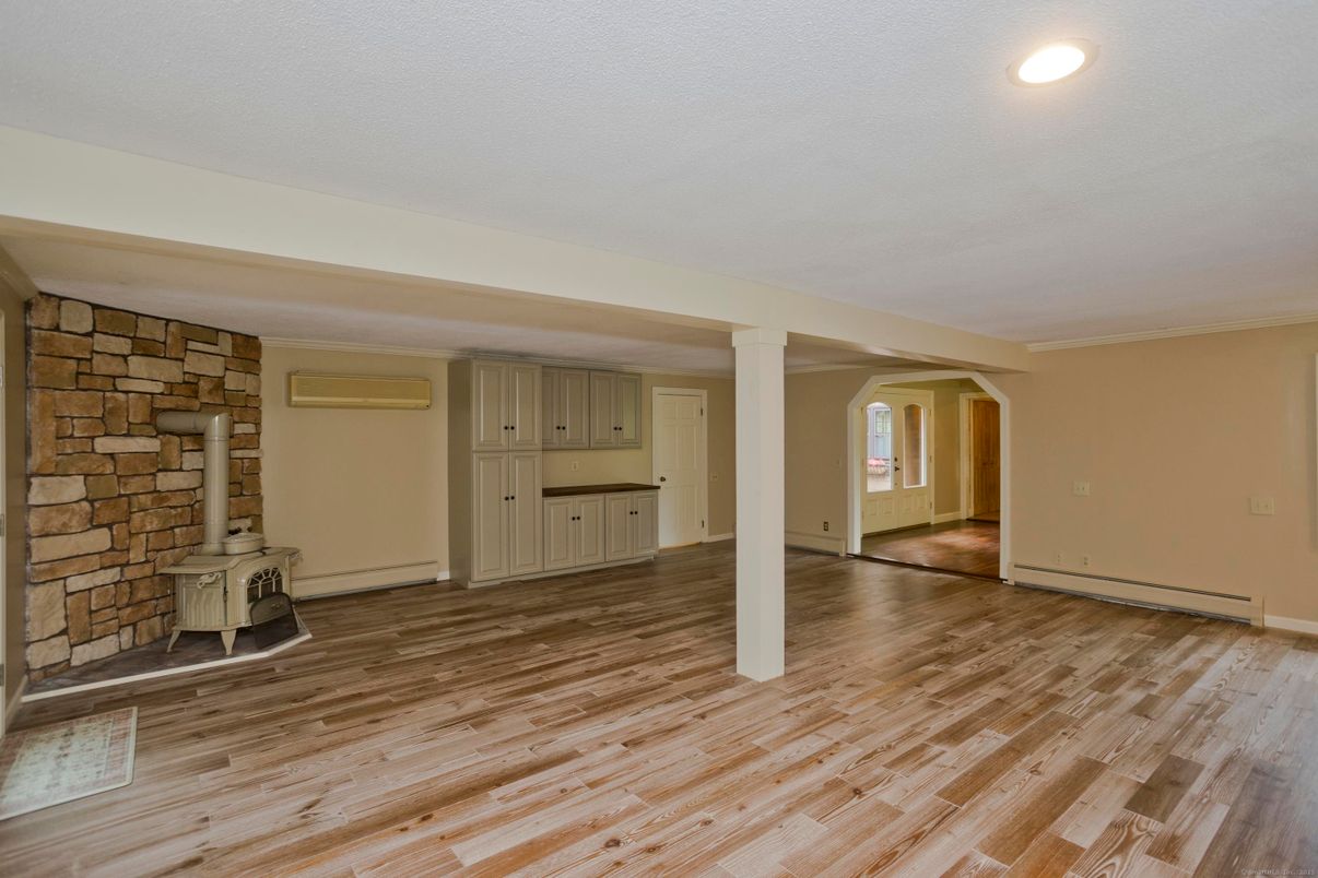 Empty room, Fireplace, Interior, Recessed Lighting, Stone Walls, Wood Texture Flooring