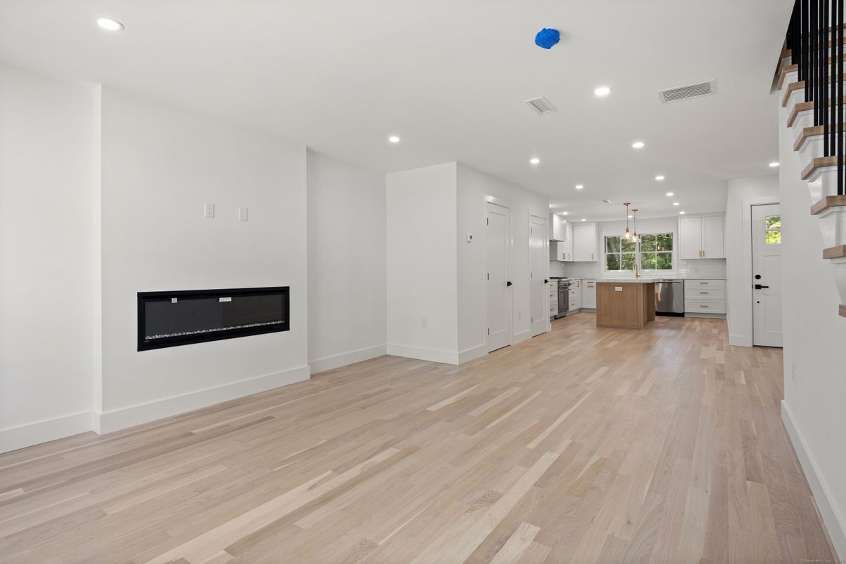 Empty room, Fireplace, Interior, Kitchen, Pendant Lights, Recessed Lighting, Wood Texture Flooring