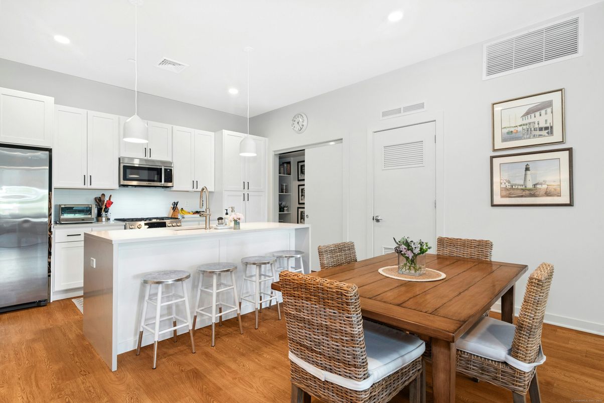 Dining room, Interior, Kitchen, Pendant Lights, Recessed Lighting, Stainless Steel Appliances, Wood Texture Flooring