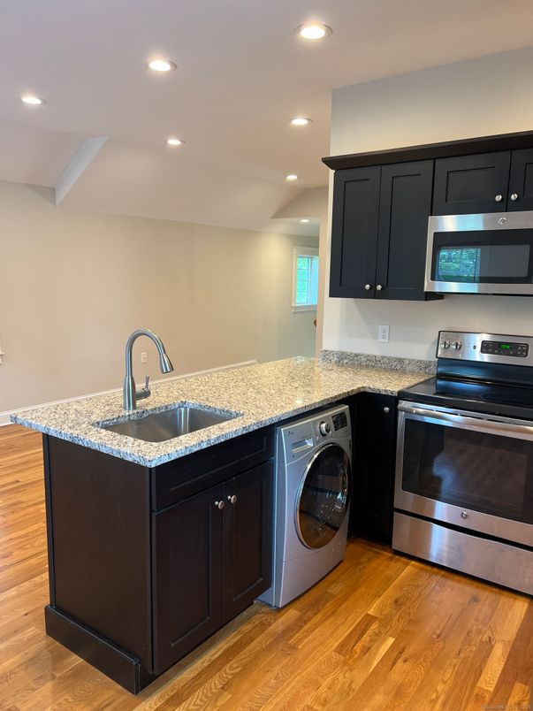 Interior, Kitchen, Recessed Lighting, Washer, Wood Texture Flooring