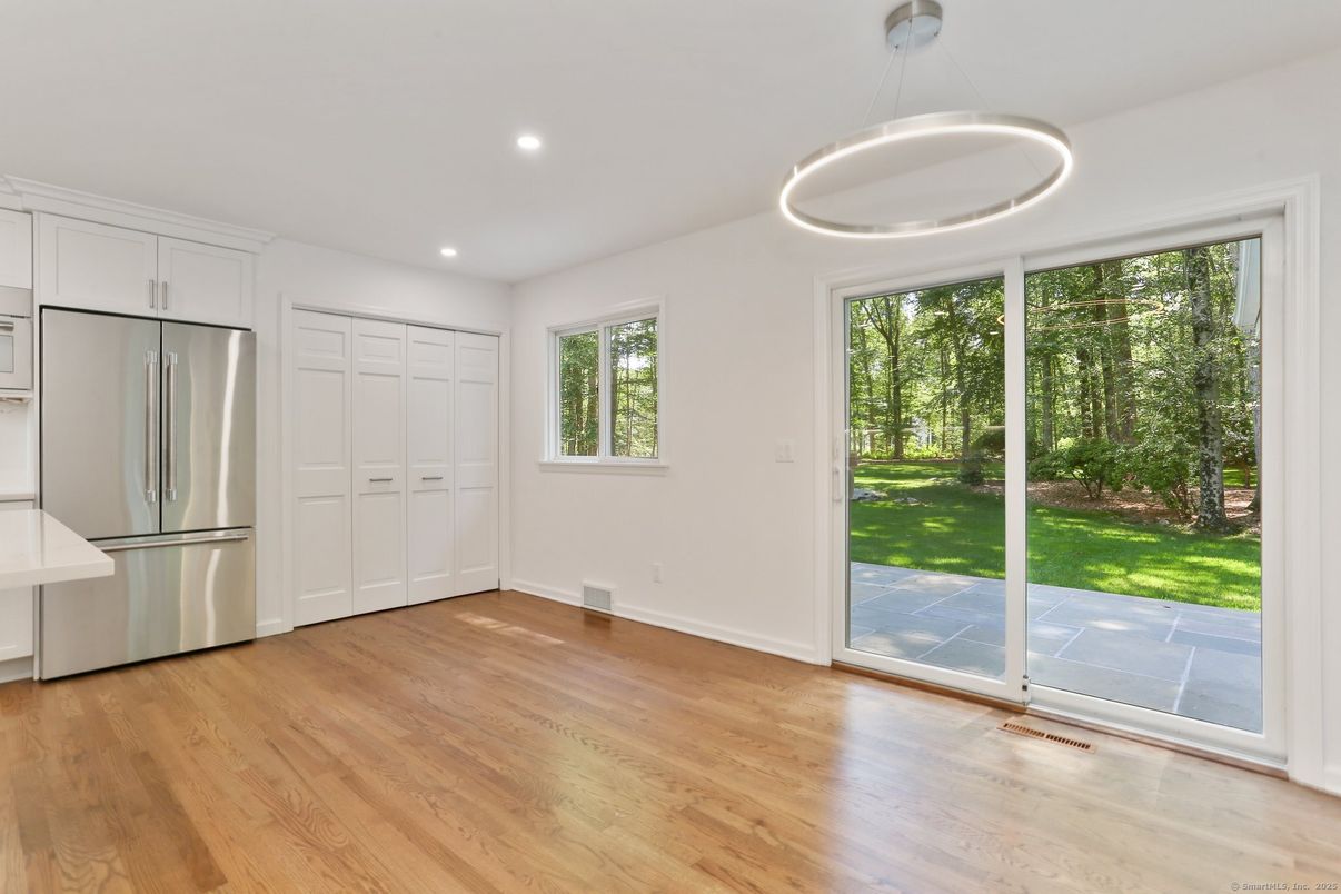 Empty room, Interior, Kitchen, Pendant Lights, Recessed Lighting, Stainless Steel Appliances, Wood Texture Flooring