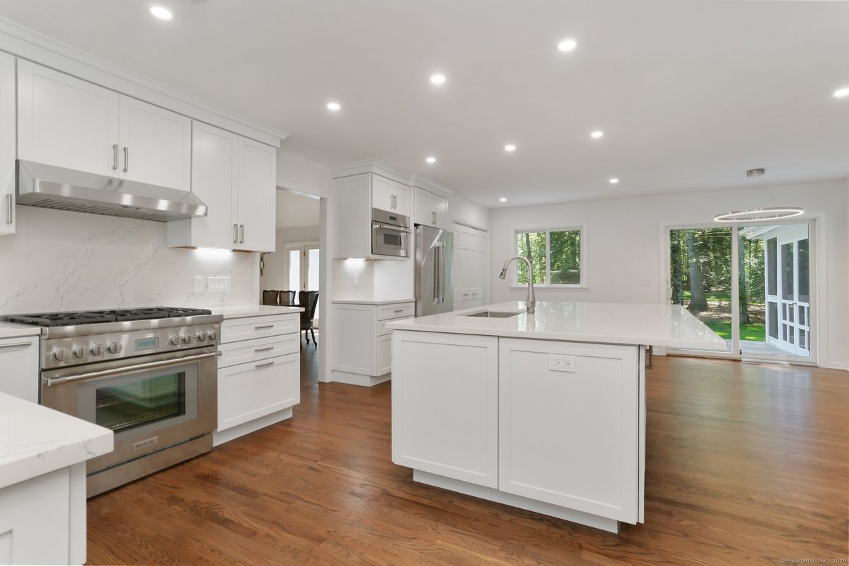 Interior, Kitchen, Marble Walls, Pendant Lights, Recessed Lighting, Stainless Steel Appliances, Wood Texture Flooring