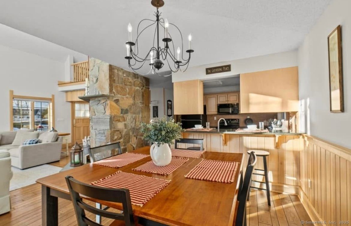 Chandelier, Dining room, Fireplace, Interior, Kitchen, Living room, Stainless Steel Appliances, Stone Walls, Wood Texture Flooring