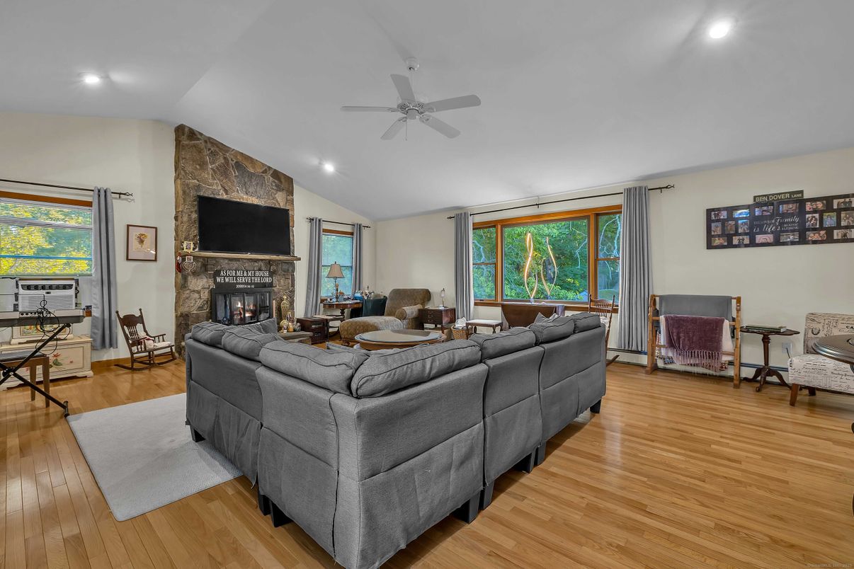 Fireplace, Interior, Living room, Recessed Lighting, Stone Walls, Wood Texture Flooring