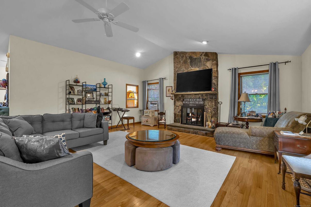 Fireplace, Interior, Living room, Recessed Lighting, Stone Walls, Wood Texture Flooring
