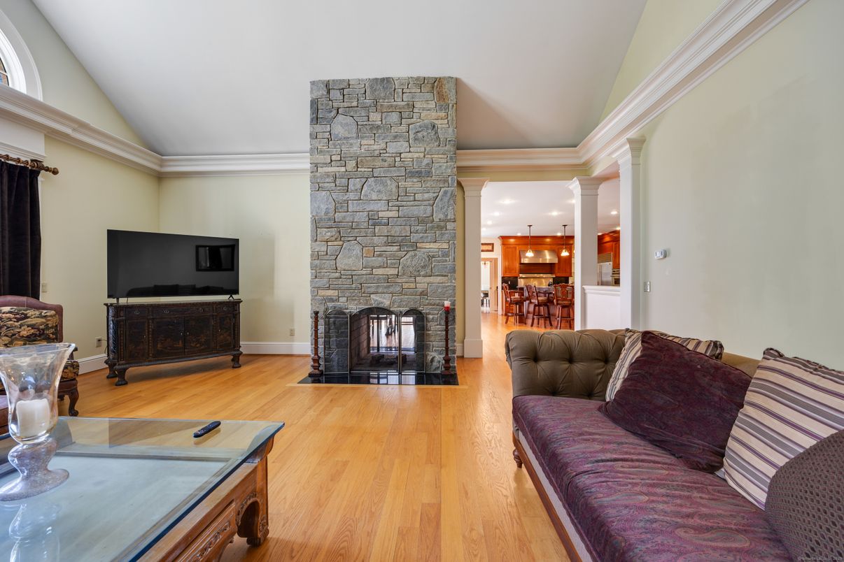 Fireplace, Interior, Living room, Recessed Lighting, Stone Walls, Wood Texture Flooring