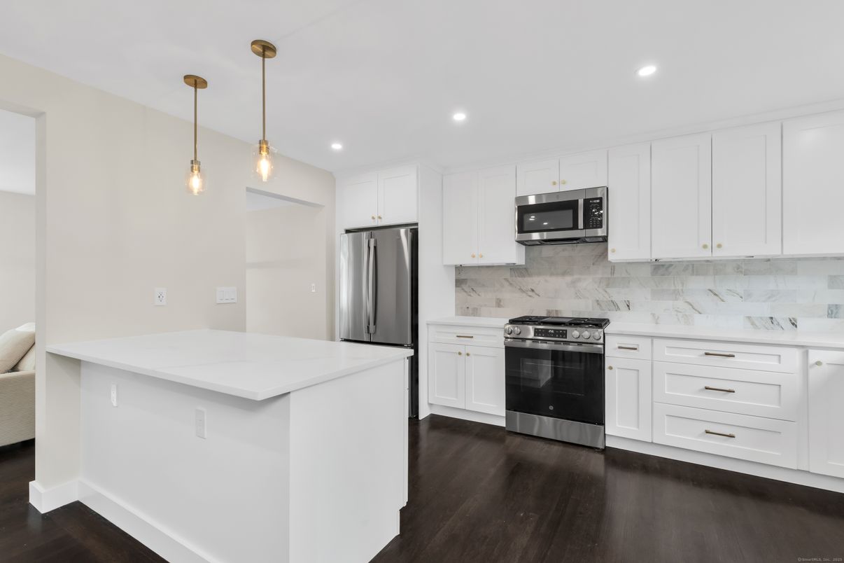 Interior, Kitchen, Marble Walls, Pendant Lights, Recessed Lighting, Stainless Steel Appliances, Wood Texture Flooring