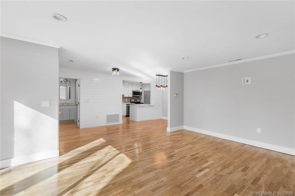 Empty room, Interior, Kitchen, Pendant Lights, Recessed Lighting, Stainless Steel Appliances, Wood Texture Flooring