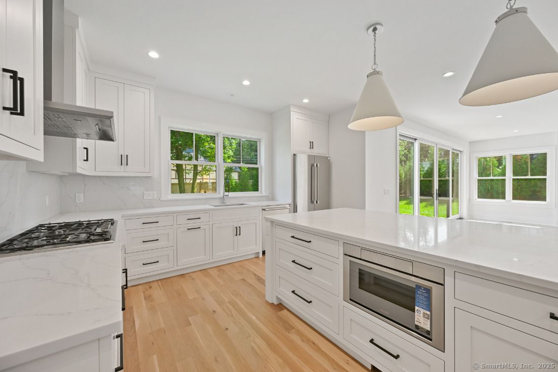 Interior, Kitchen, Marble Walls, Pendant Lights, Recessed Lighting, Stainless Steel Appliances, Wood Texture Flooring
