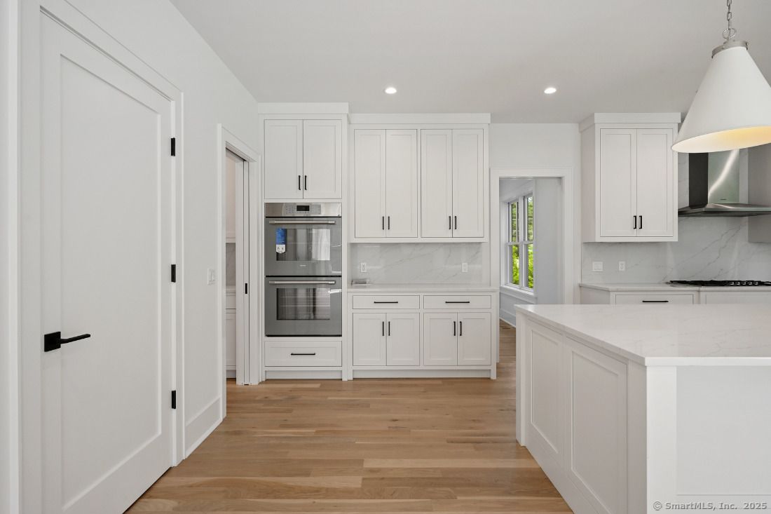 Interior, Kitchen, Marble Walls, Pendant Lights, Recessed Lighting, Stainless Steel Appliances, Wood Texture Flooring