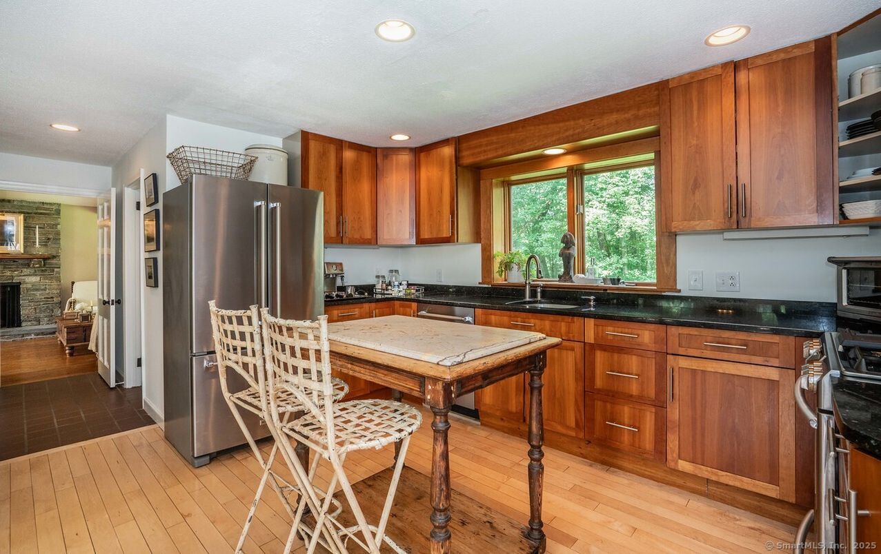 Dining room, Fireplace, Interior, Kitchen, Recessed Lighting, Stone Walls, Wood Texture Flooring