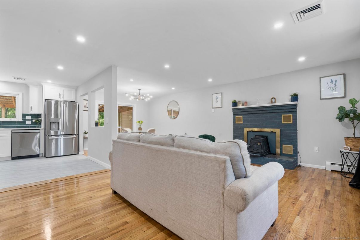 Fireplace, Interior, Kitchen, Living room, Pendant Lights, Recessed Lighting, Stainless Steel Appliances, Wood Texture Flooring