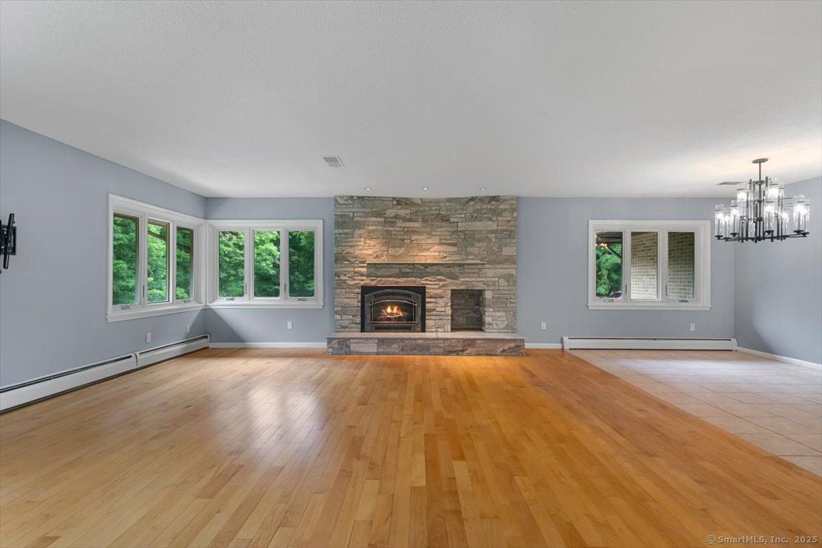 Chandelier, Empty room, Fireplace, Interior, Stone Walls, Wood Texture Flooring