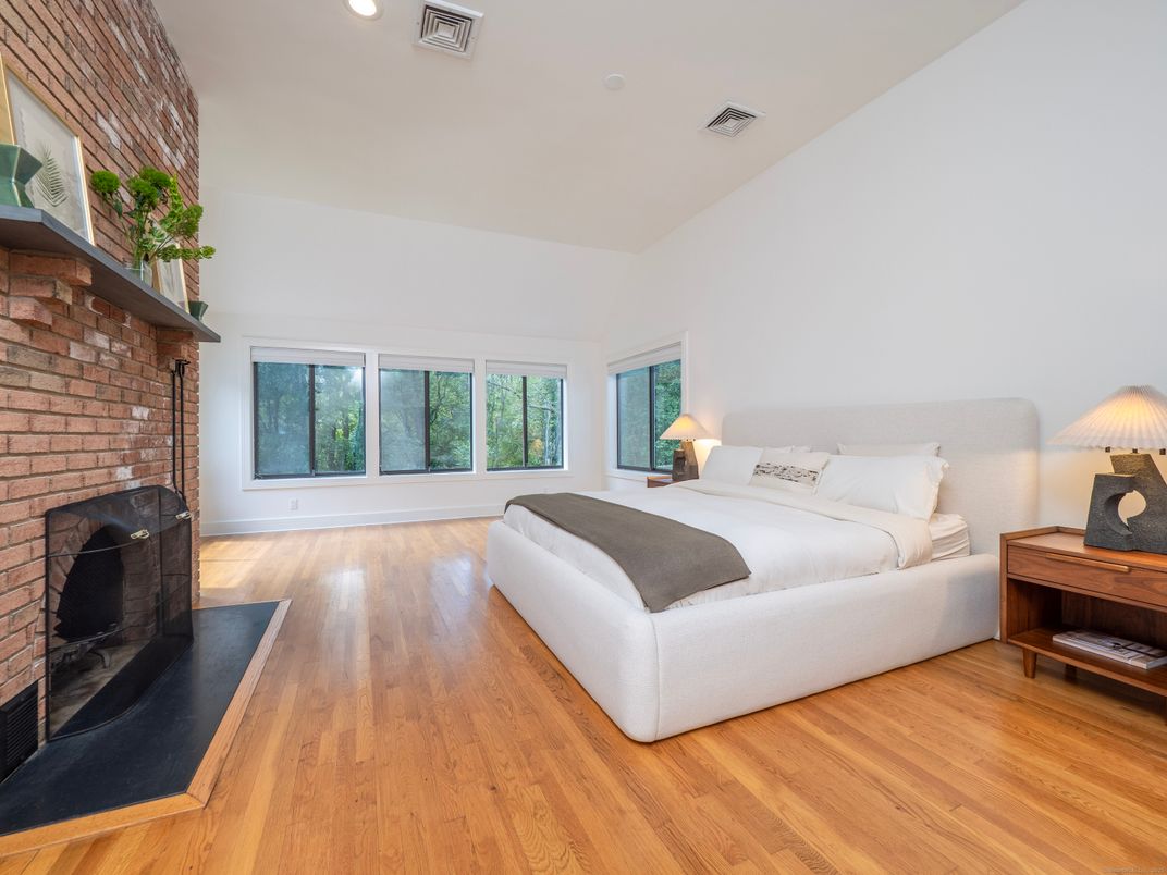 Bedroom, Fireplace, Interior, Recessed Lighting, Stone Walls, Wood Texture Flooring
