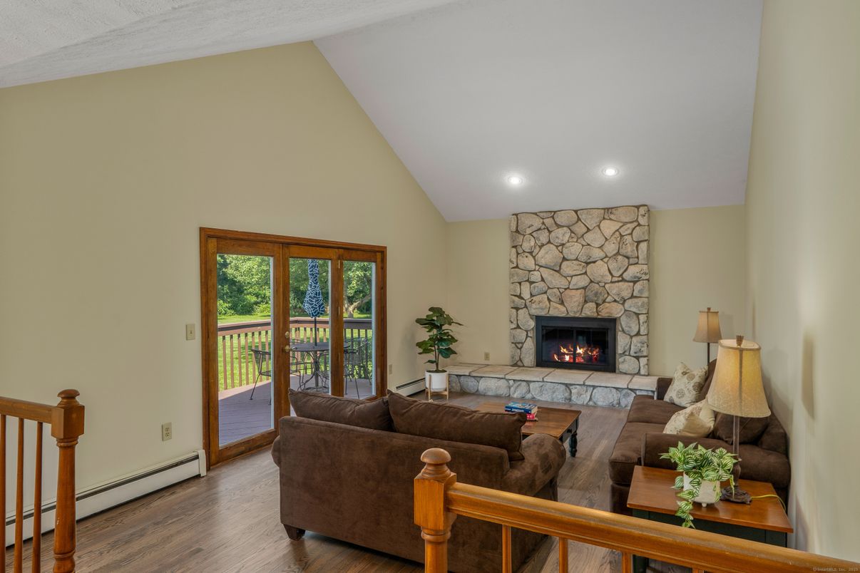 Fireplace, Interior, Living room, Recessed Lighting, Stone Walls, Wood Texture Flooring