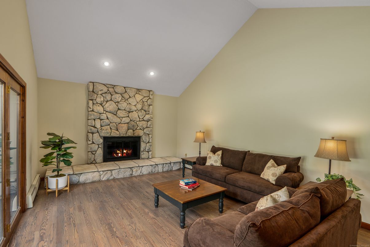 Fireplace, Interior, Living room, Recessed Lighting, Stone Walls, Wood Texture Flooring