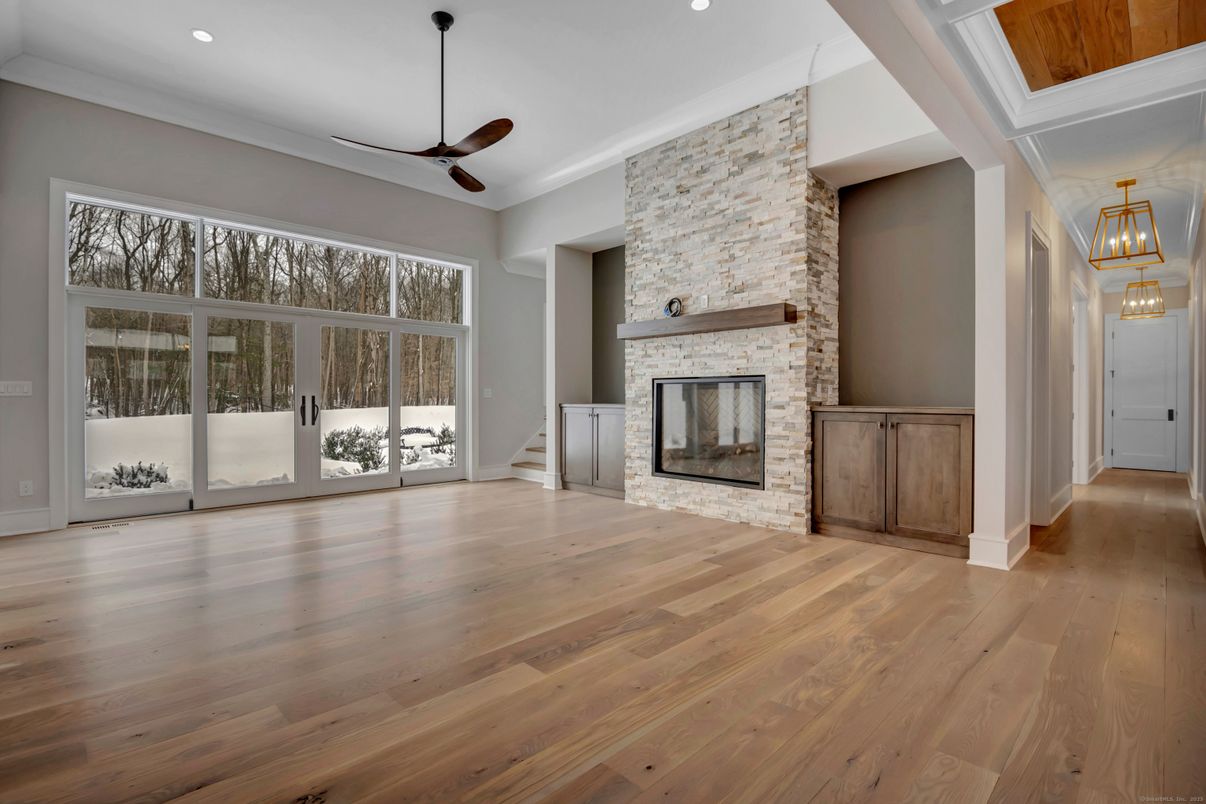 Empty room, Fireplace, Interior, Pendant Lights, Recessed Lighting, Stone Walls, Wood Texture Flooring
