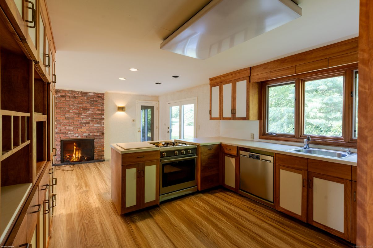 Fireplace, Interior, Kitchen, Recessed Lighting, Stainless Steel Appliances, Stone Walls, Wood Texture Flooring