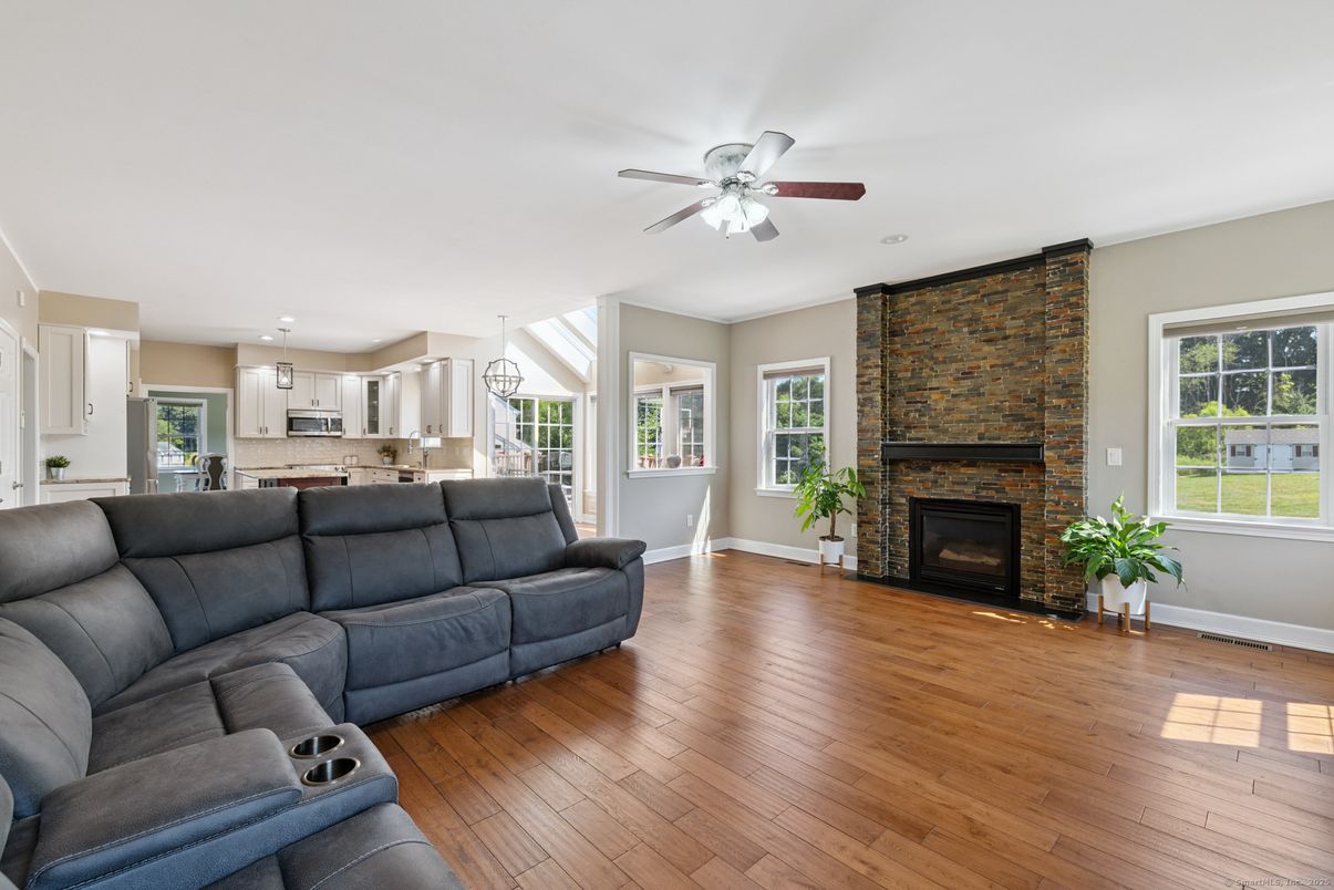 Fireplace, Interior, Kitchen, Living room, Pendant Lights, Stainless Steel Appliances, Stone Walls, Wood Texture Flooring