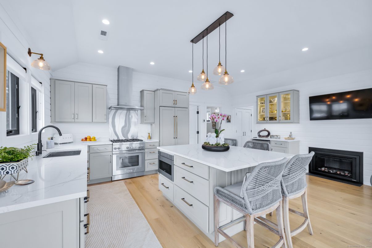 Fireplace, Interior, Kitchen, Pendant Lights, Recessed Lighting, Stainless Steel Appliances, Wood Texture Flooring