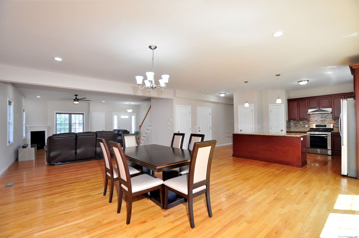 Chandelier, Dining room, Interior, Kitchen, Living room, Pendant Lights, Recessed Lighting, Stainless Steel Appliances, Wood Texture Flooring