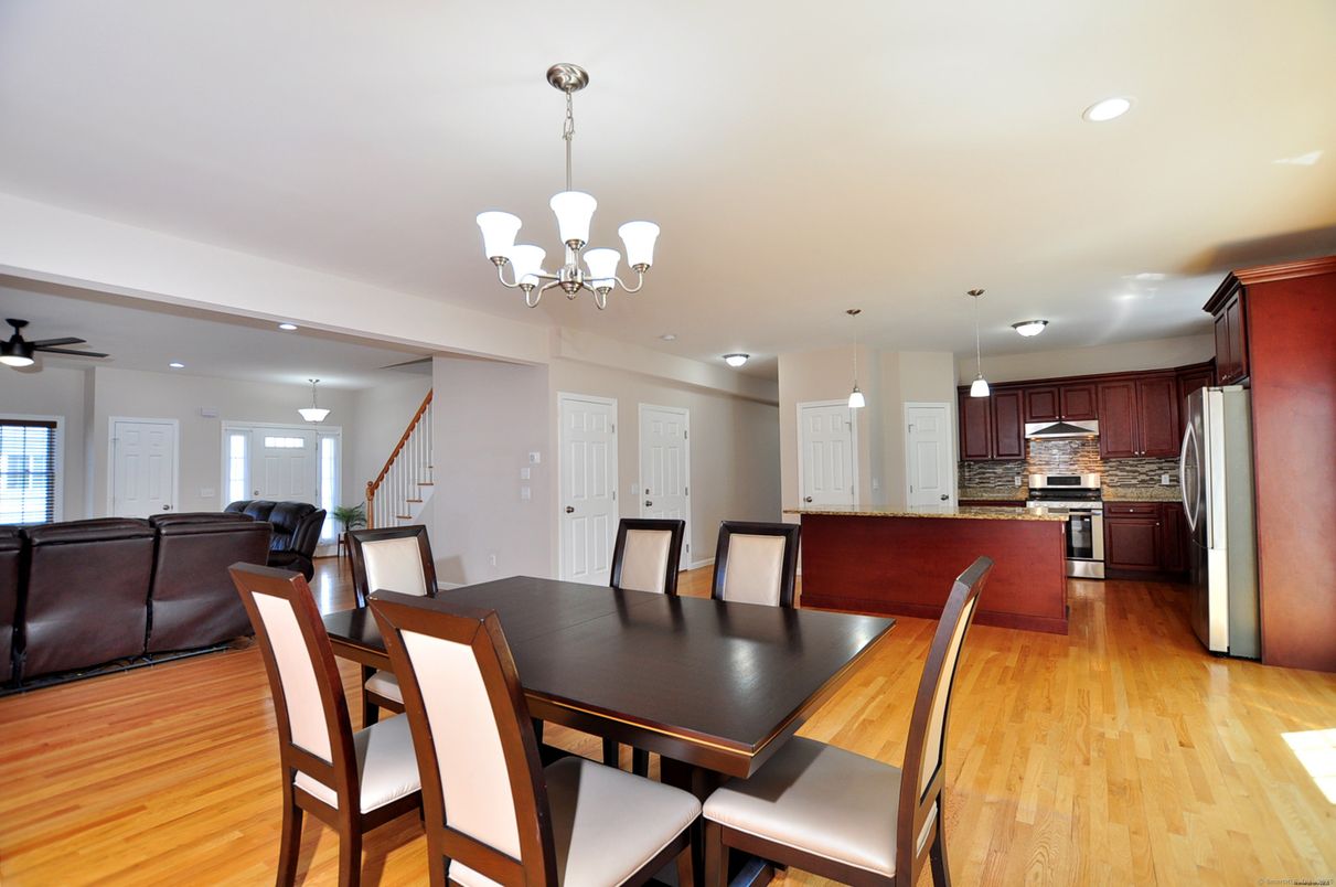 Chandelier, Dining room, Interior, Kitchen, Living room, Pendant Lights, Recessed Lighting, Stainless Steel Appliances, Wood Texture Flooring
