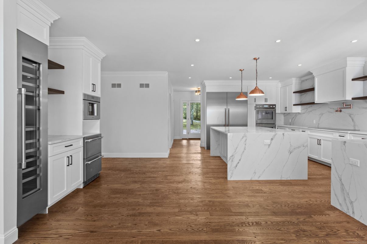 Interior, Kitchen, Marble Walls, Pendant Lights, Recessed Lighting, Stainless Steel Appliances, Wood Texture Flooring