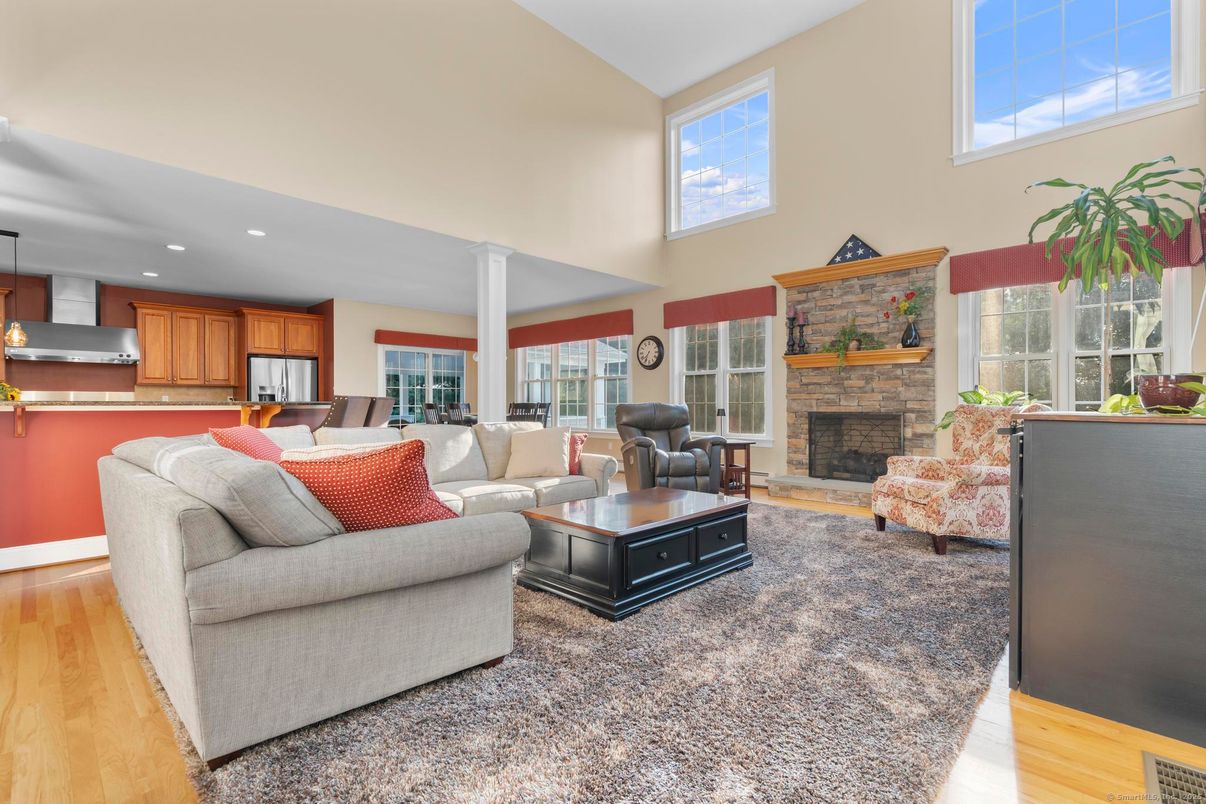 Fireplace, Interior, Kitchen, Living room, Pendant Lights, Recessed Lighting, Stainless Steel Appliances, Stone Walls, Wood Texture Flooring