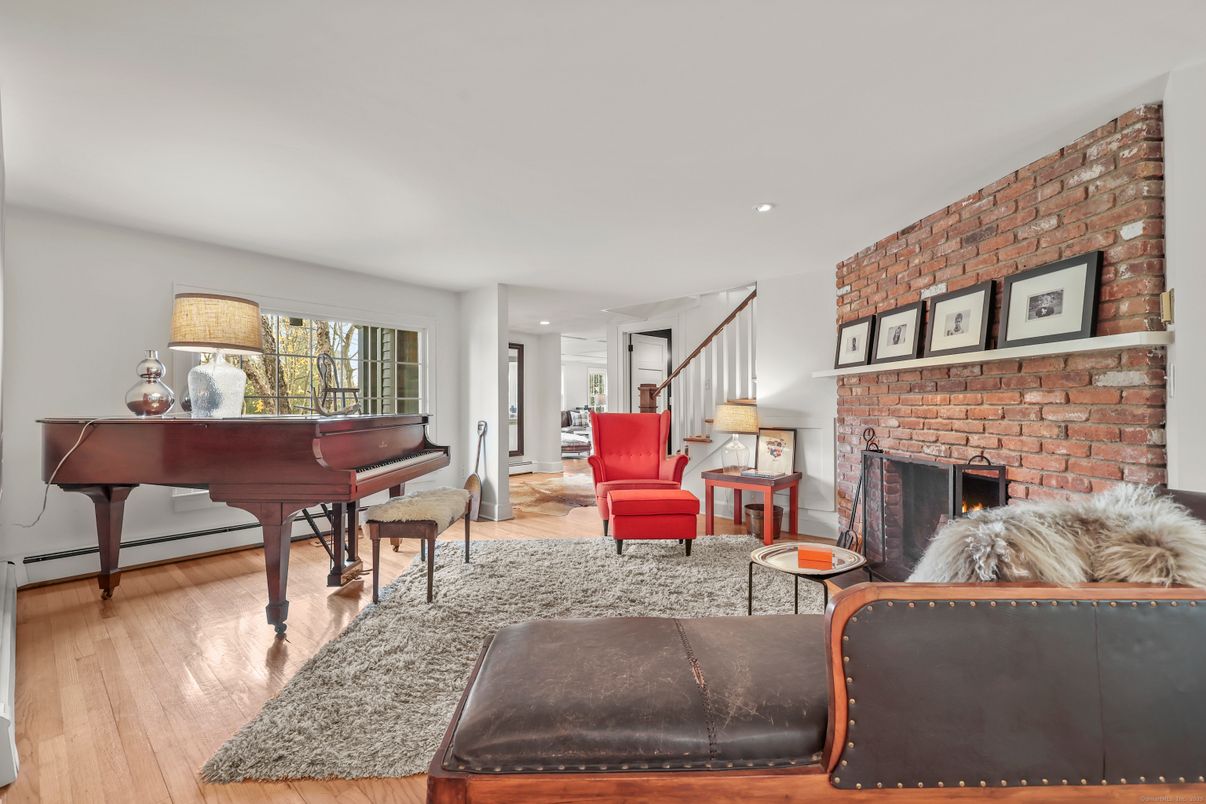 Fireplace, Interior, Living room, Piano, Recessed Lighting, Stone Walls, Wood Texture Flooring