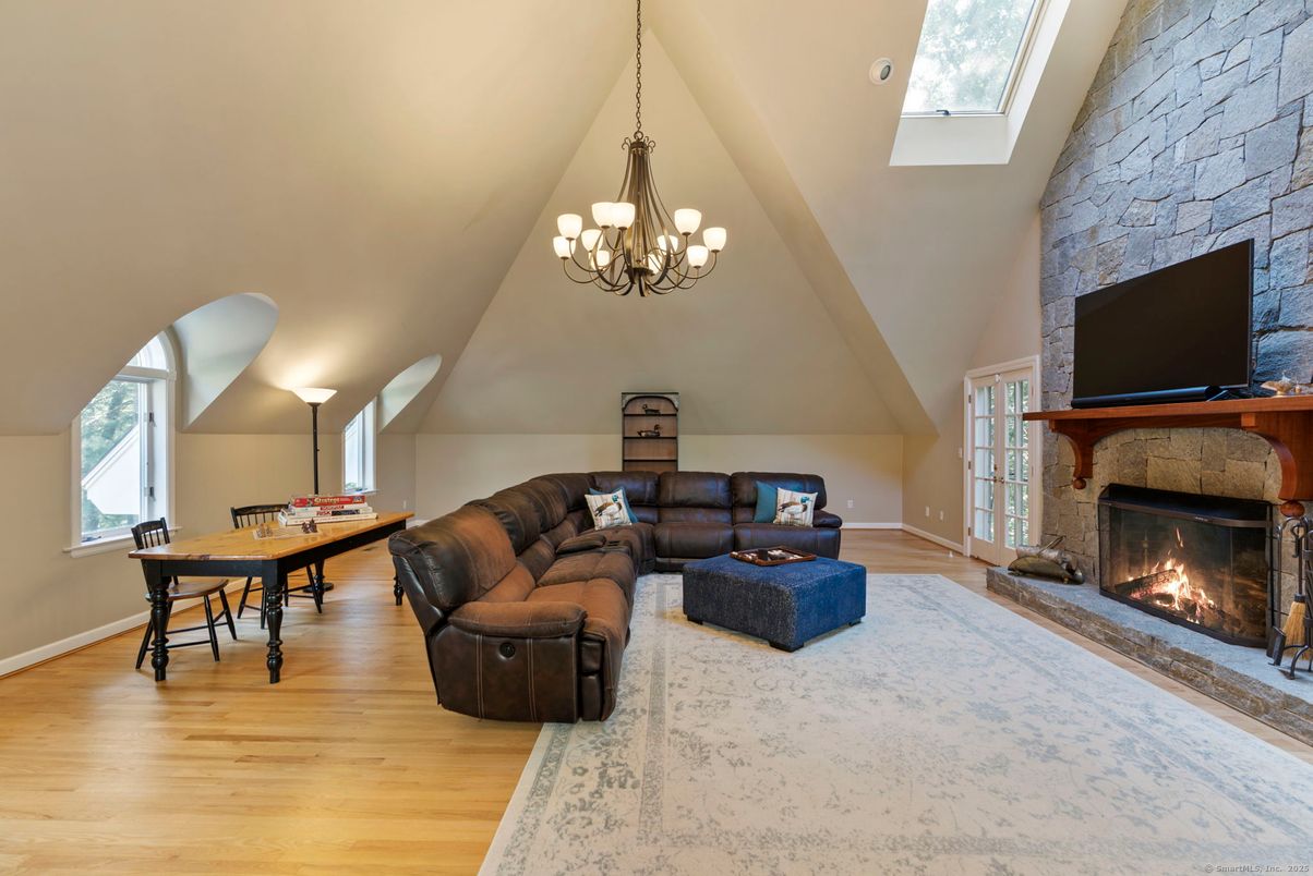 Chandelier, Dining room, Fireplace, Interior, Living room, Stone Walls, Wood Texture Flooring