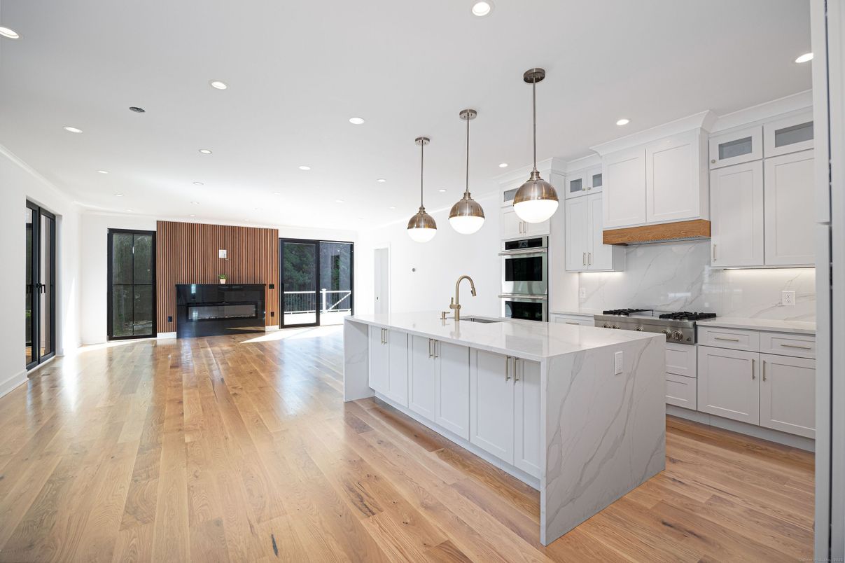 Interior, Kitchen, Marble Walls, Pendant Lights, Recessed Lighting, Stainless Steel Appliances, Wood Texture Flooring