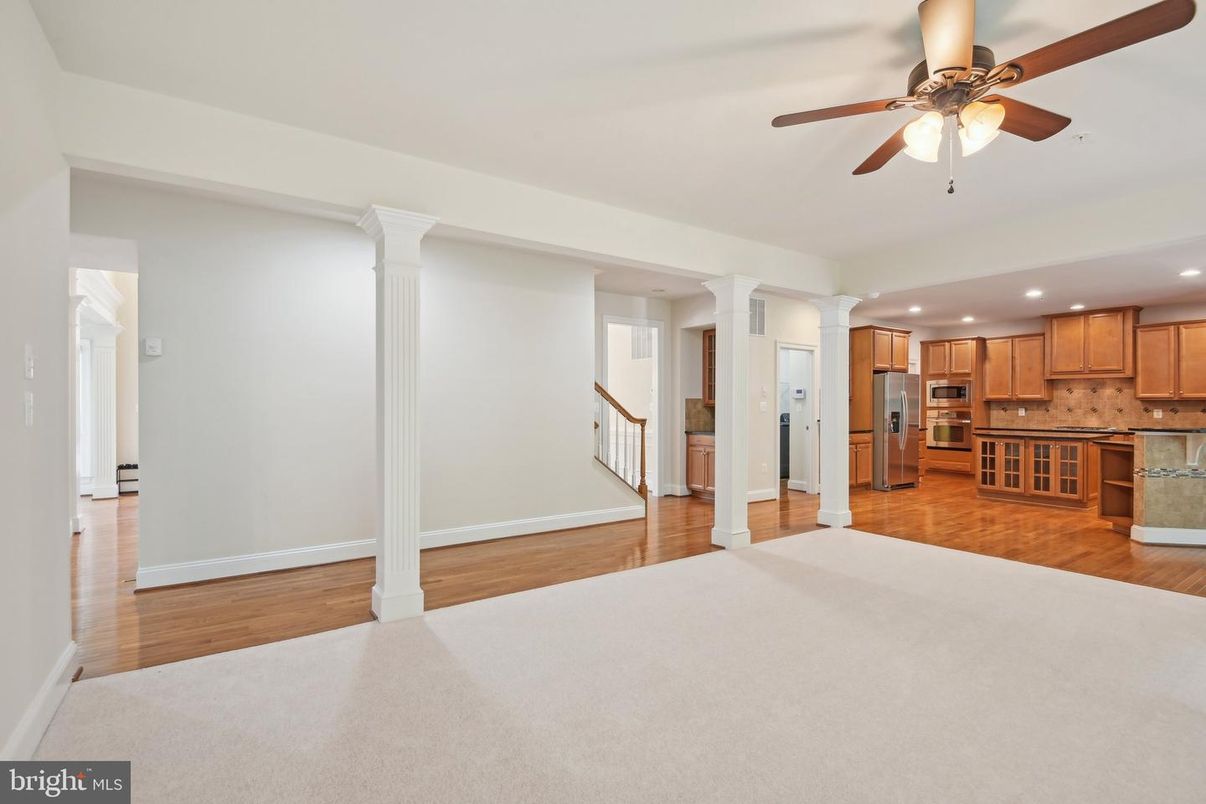 Empty room, Interior, Kitchen, Recessed Lighting, Stainless Steel Appliances, Wood Texture Flooring