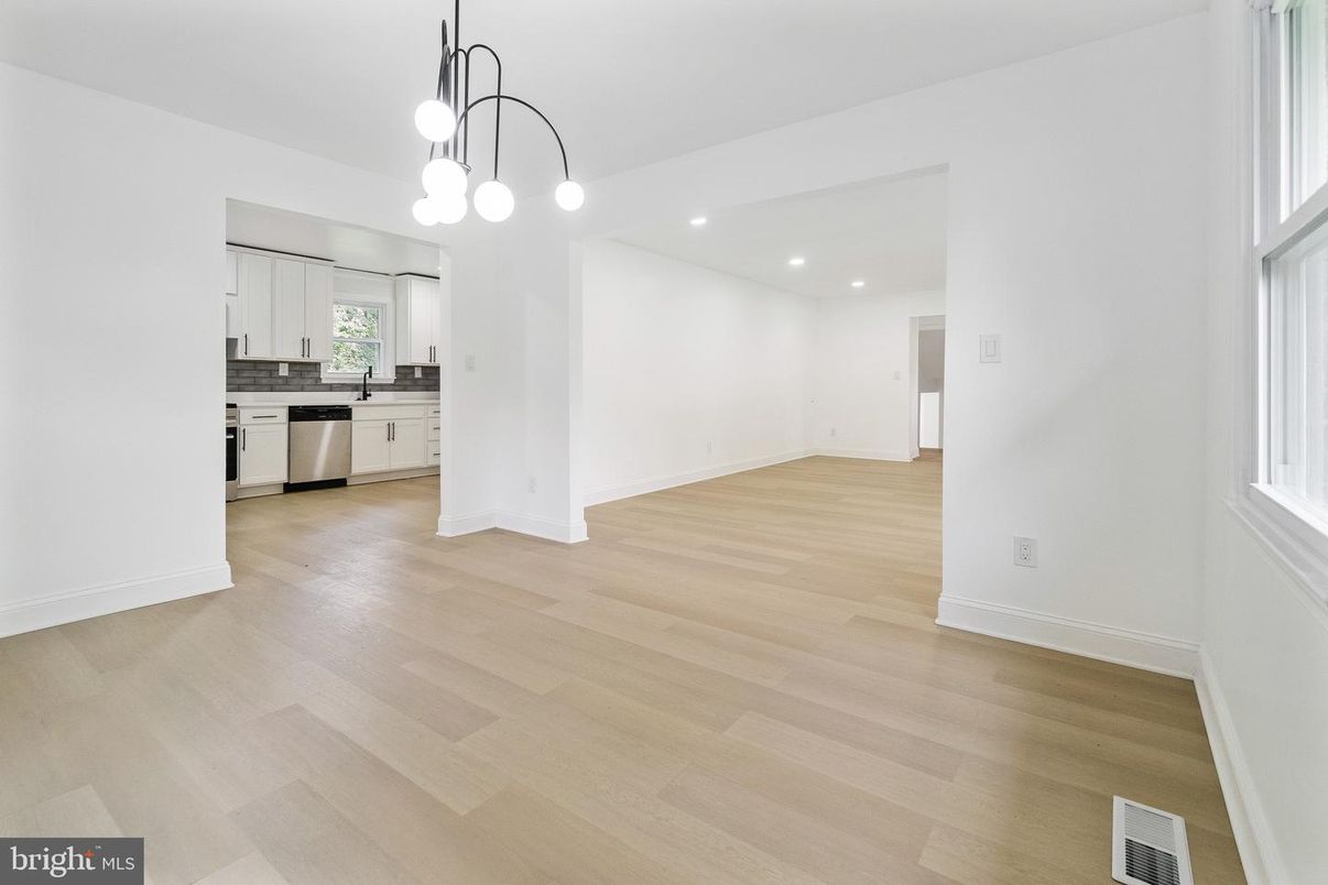 Empty room, Interior, Kitchen, Pendant Lights, Recessed Lighting, Stainless Steel Appliances, Wood Texture Flooring