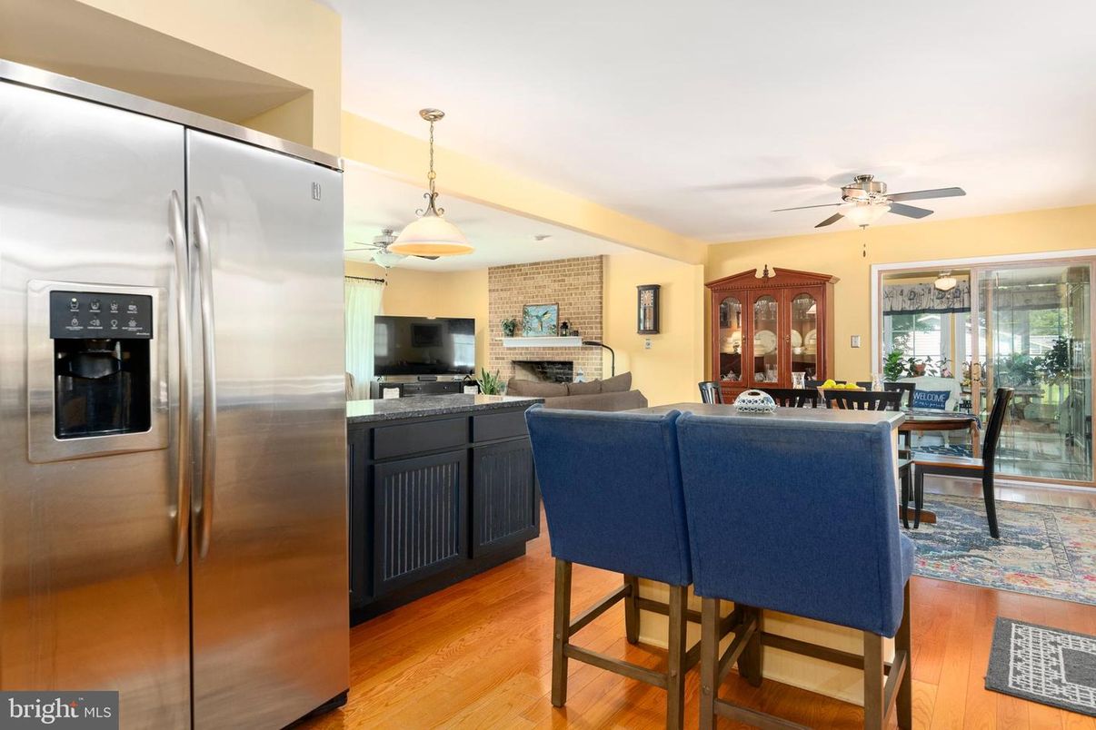 Dining room, Fireplace, Interior, Kitchen, Living room, Pendant Lights, Stainless Steel Appliances, Stone Walls, Wood Texture Flooring