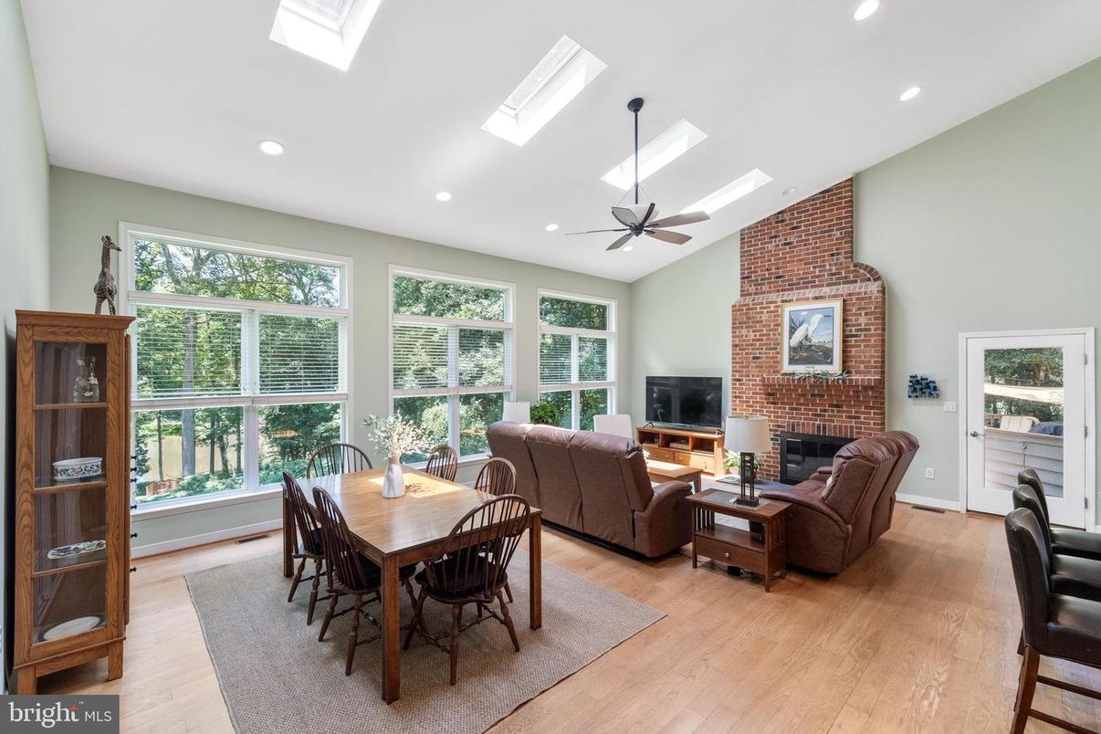Dining room, Fireplace, Interior, Living room, Recessed Lighting, Stone Walls, Wood Texture Flooring