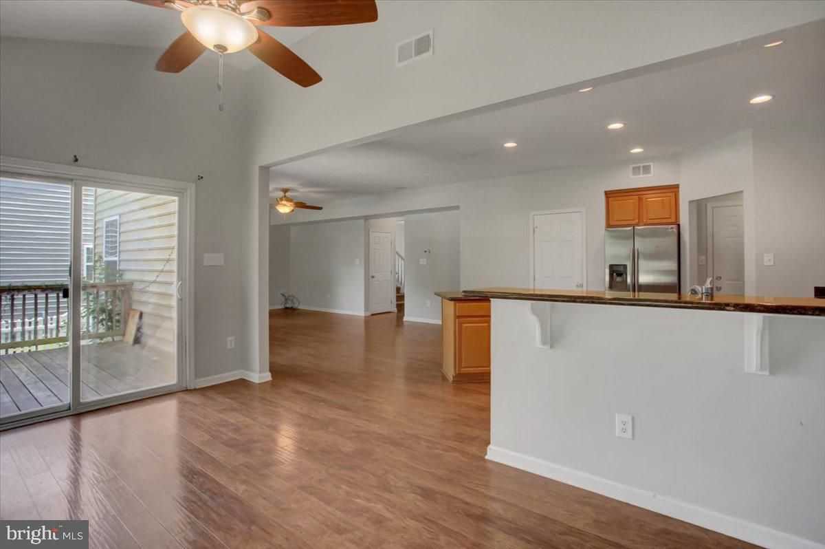 Empty room, Interior, Kitchen, Recessed Lighting, Stainless Steel Appliances, Wood Texture Flooring