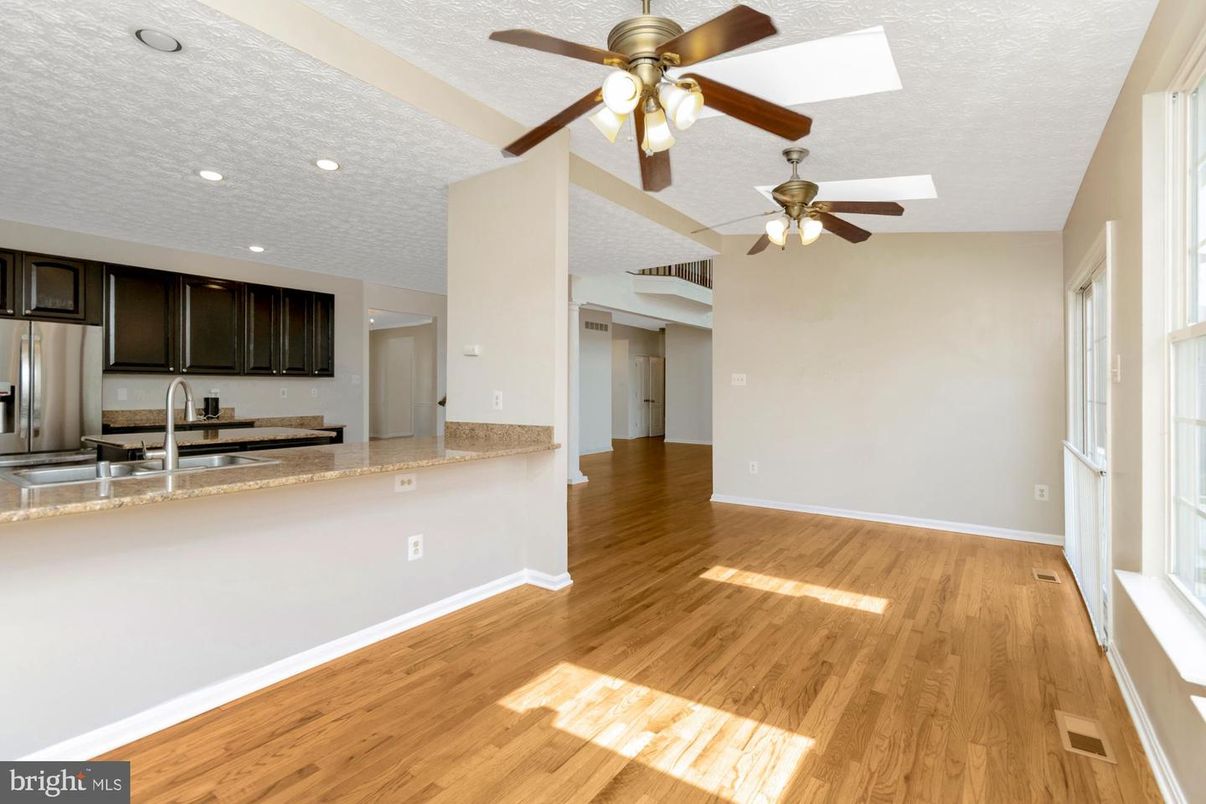 Empty room, Interior, Kitchen, Recessed Lighting, Stainless Steel Appliances, Wood Texture Flooring