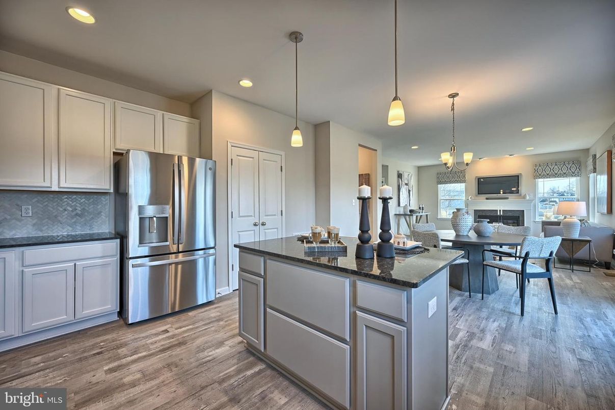 Chandelier, Dining room, Fireplace, Interior, Kitchen, Pendant Lights, Recessed Lighting, Stainless Steel Appliances, Wood Texture Flooring