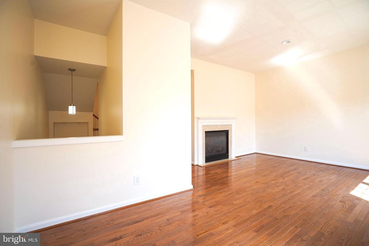 Empty room, Fireplace, Interior, Pendant Lights, Recessed Lighting, Wood Texture Flooring