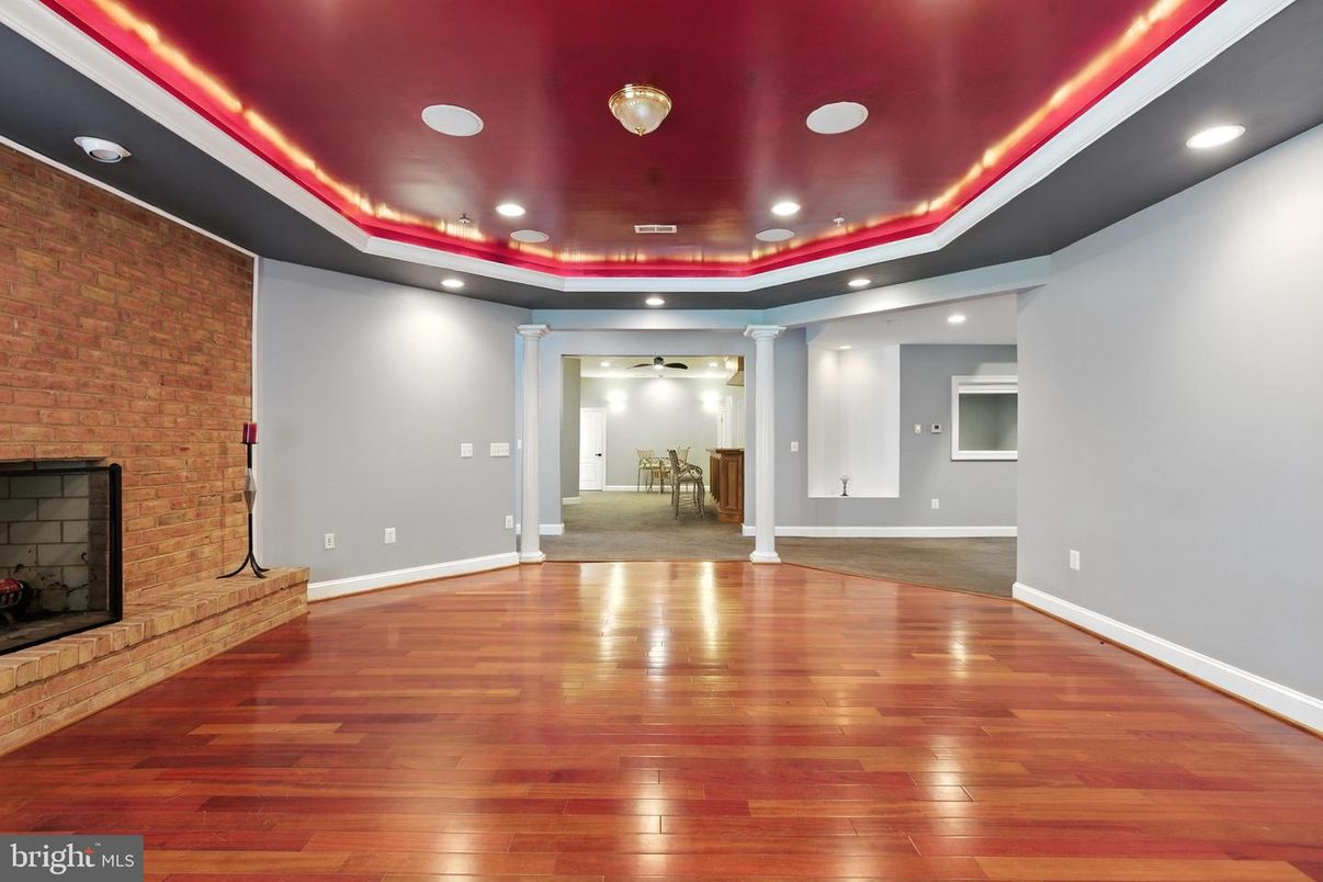 Empty room, Fireplace, Interior, Recessed Lighting, Stone Walls, Wood Texture Flooring