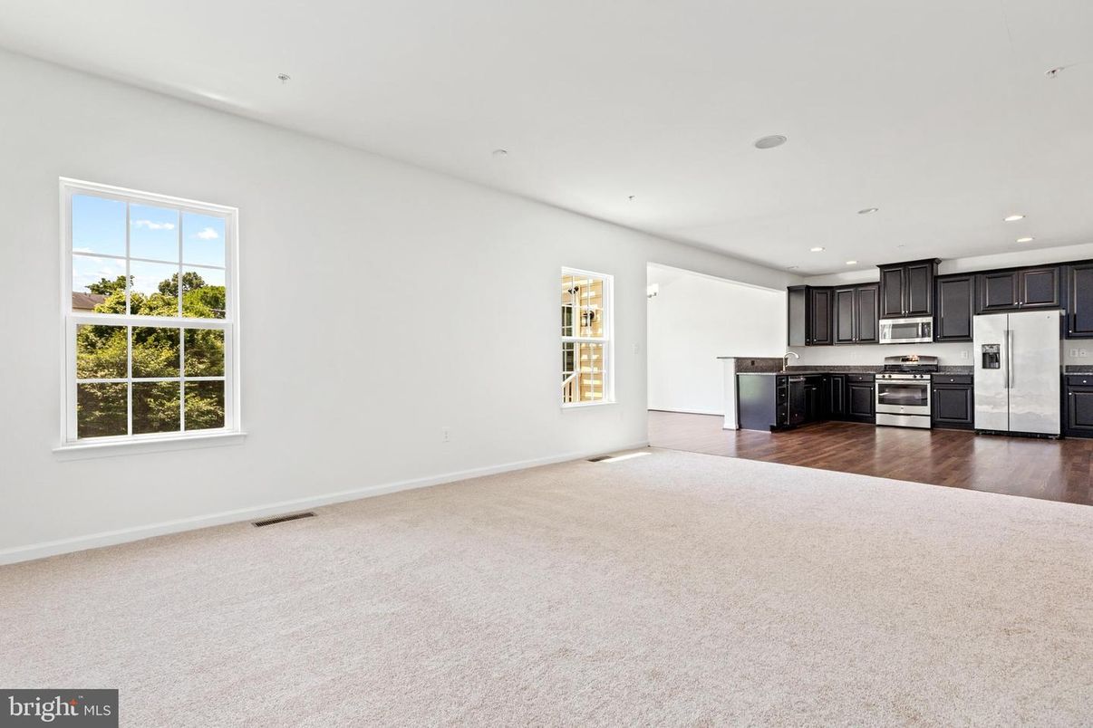 Empty room, Interior, Kitchen, Recessed Lighting, Stainless Steel Appliances, Wood Texture Flooring