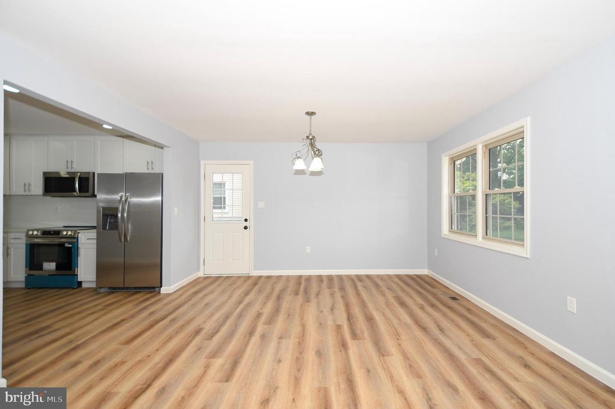 Empty room, Interior, Kitchen, Pendant Lights, Stainless Steel Appliances, Wood Texture Flooring